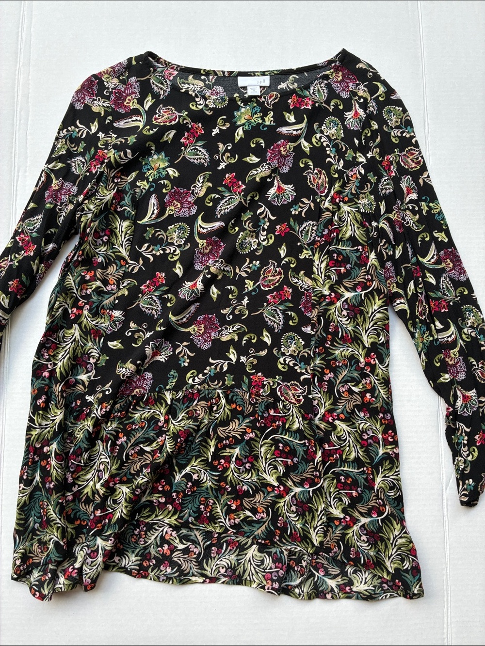 Black tunic with colorful floral pattern and ruffle hem